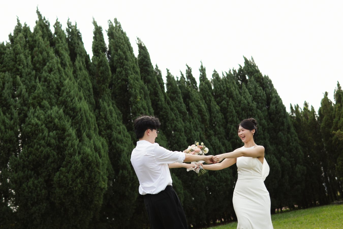 Darren and Jade dancing together in front of tall trees